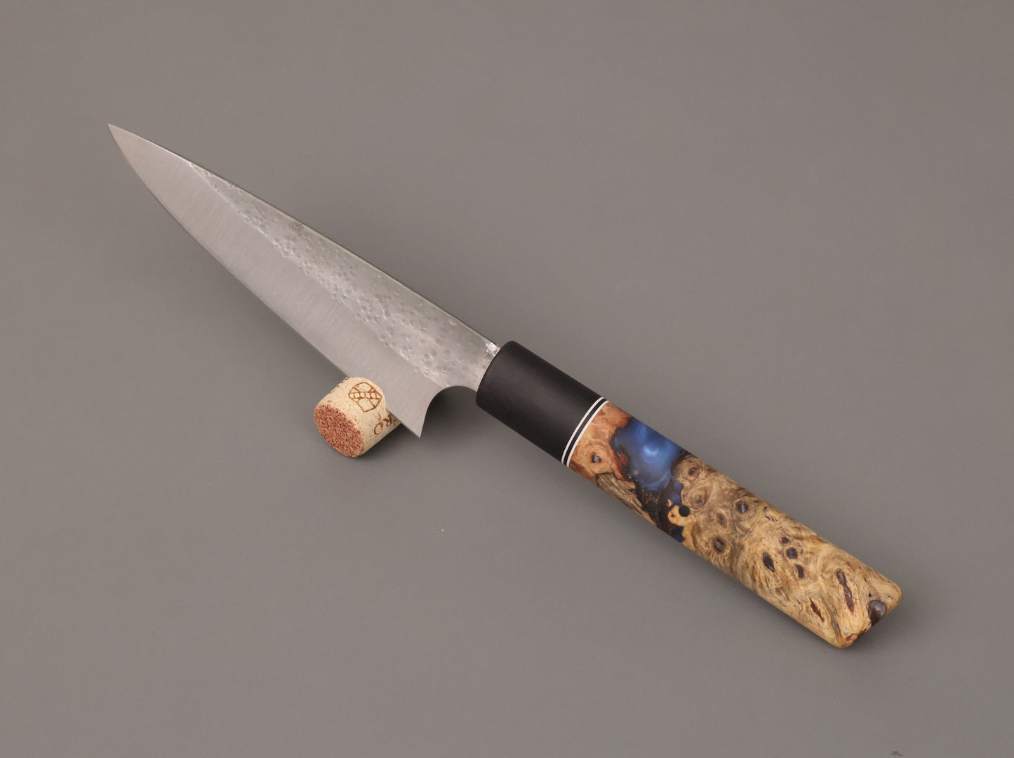 kitchen knife with wood and resin hybrid handle on gray background