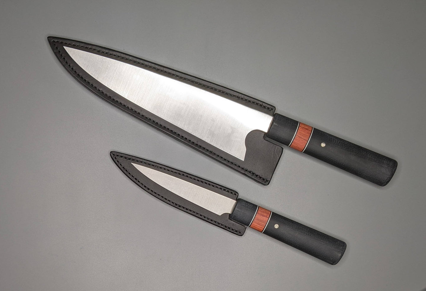 Chef and paring knives with leather sheaths