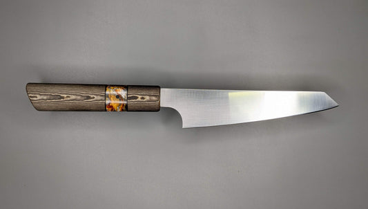 small Japanese kitchen knife with brown handle on gray background