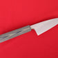 mid-size kitchen knife on red background. Petty with green and black SureTouch handle.