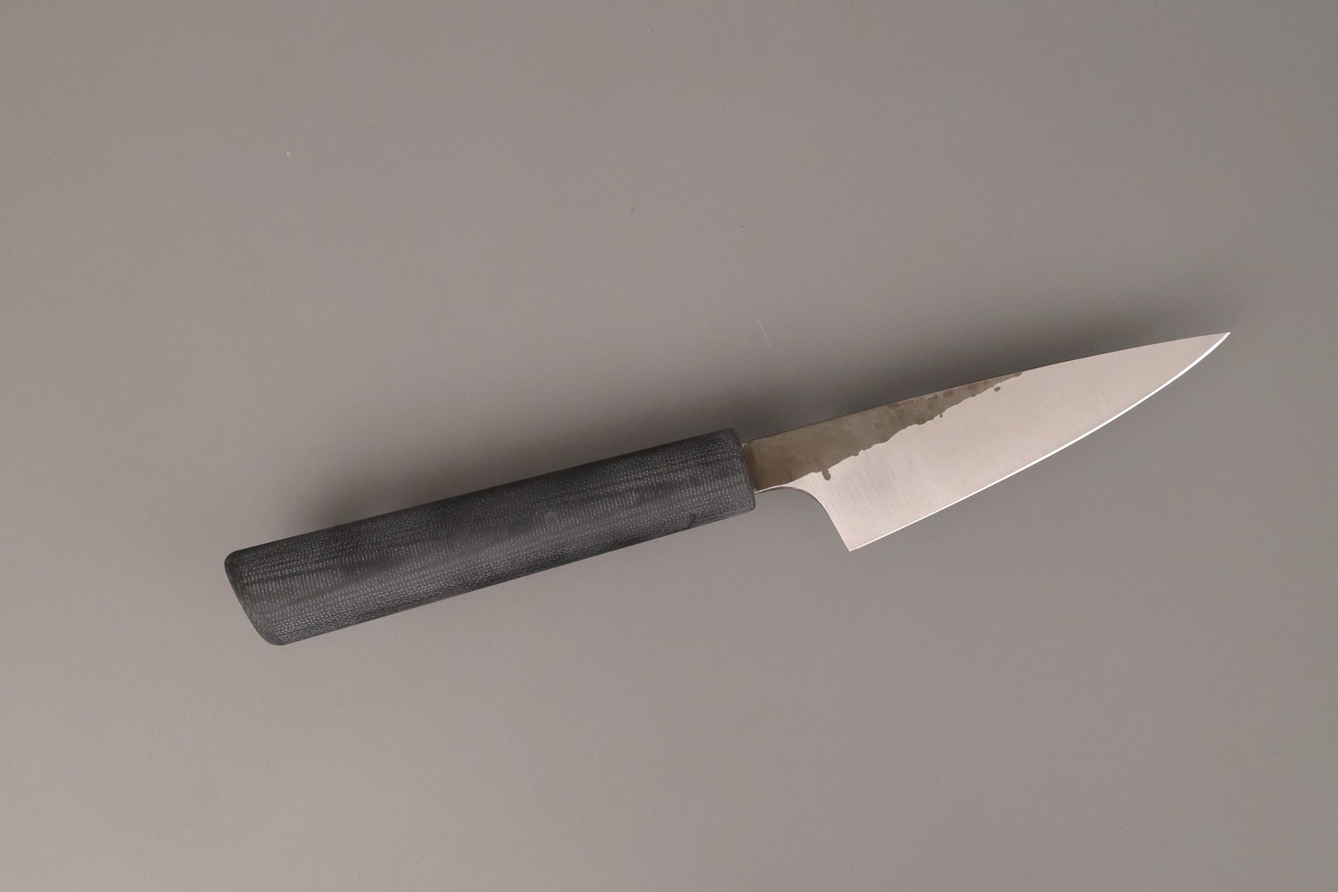 Small kitchen knife with black Micarta handle