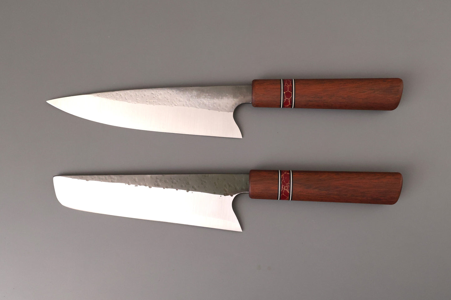 Set of two kitchen knives with Ipe wooden handles on gray background