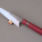 Kitchen knife with Purple Hart wooden handle on gray background