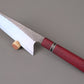 Nakiri kitchen knife with S-grind and Purple Hart wooden handle on gray background.