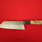 Japanese style Bunka kitchen knife with wooden handle on a red background