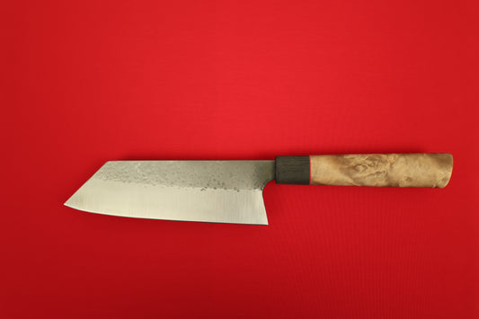Japanese style Bunka kitchen knife with wooden handle on a red background