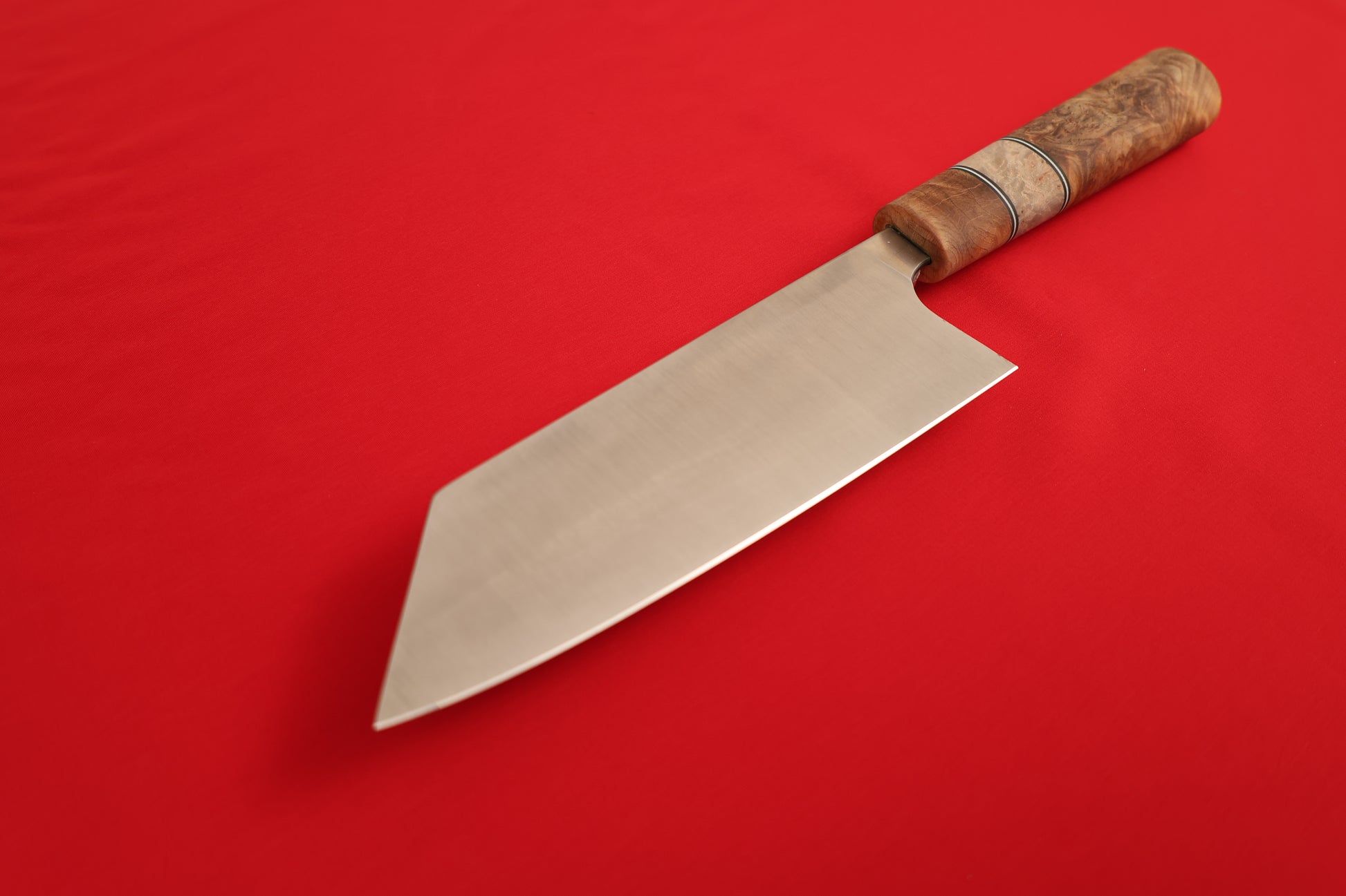Bunka with a wooden handle on a red background.