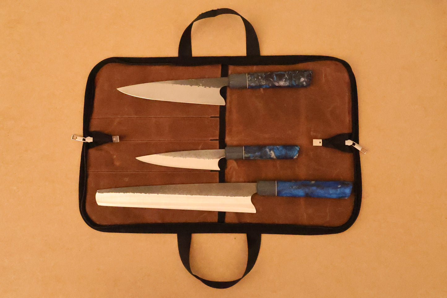 Gift Set of knives in a brown waxed canvas case on a beige background