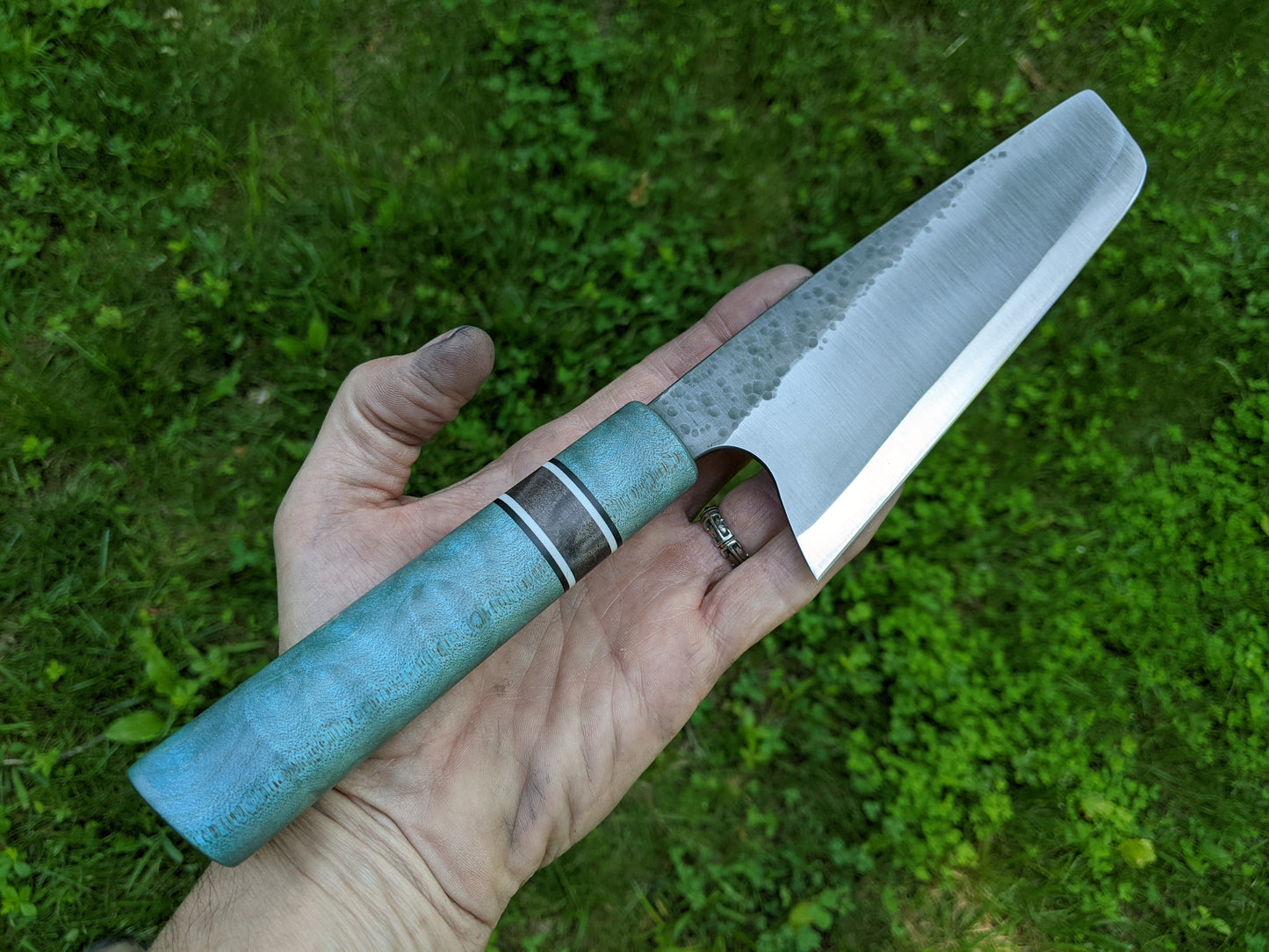 S-Grind Nakiri held in and open hand with grass background