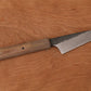 small kitchen knife with Micarta handle on a wooden cutting board