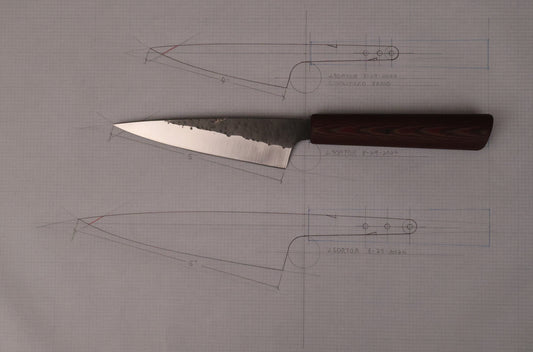 small kitchen knife on top of drawings of knives