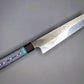 Japanese style kitchen knife with blue handle and hammered finish on blade 