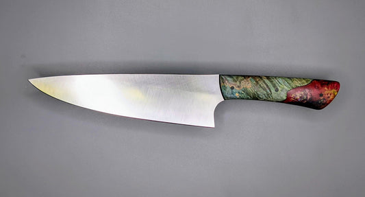Chef knife on gray background with hybrid handle of green dye Maple and red resin