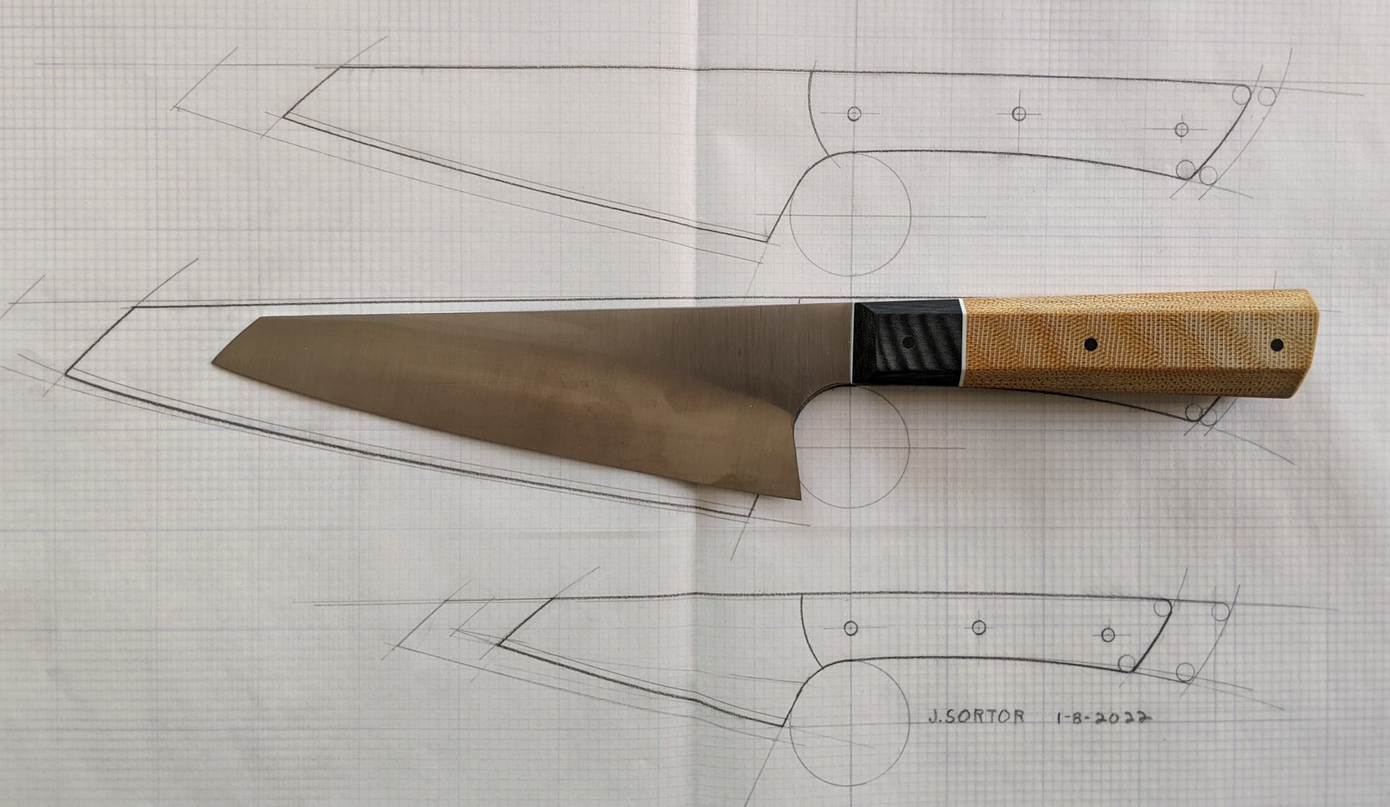 Japanese kitchen knife with drawing in background 