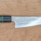 Japanese kitchen knife on wooden background 