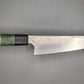 Japanese kitchen knife on gray background with green and black handle
