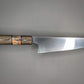 Japanese kitchen knife on gray background with brown handle