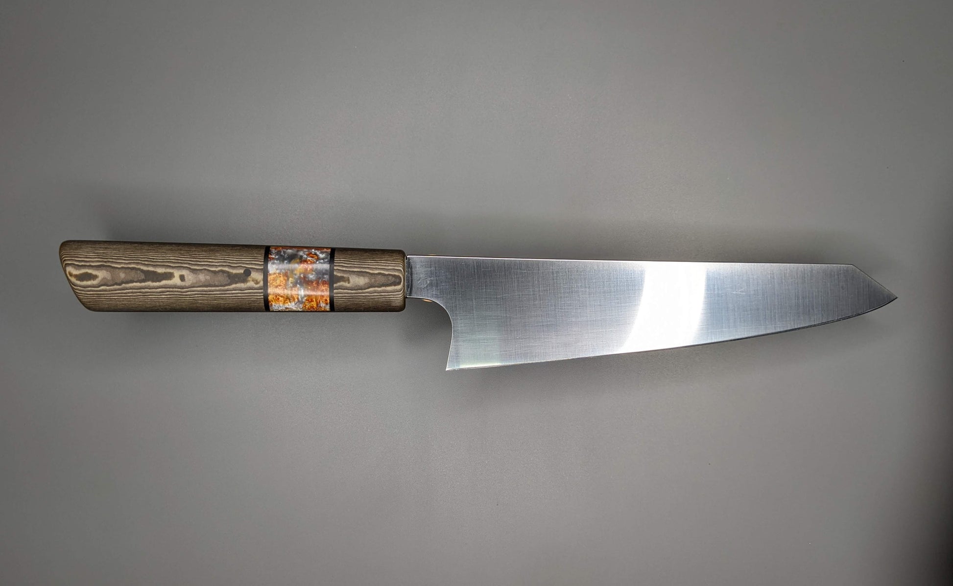 Japanese kitchen knife on gray background with brown handle