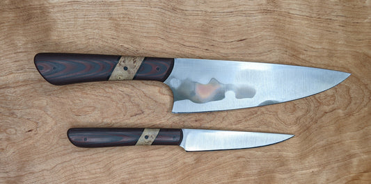 chef and paring knife on wooden background