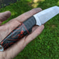 Wharncliffe blade knife with black and red Kirinite handle. 