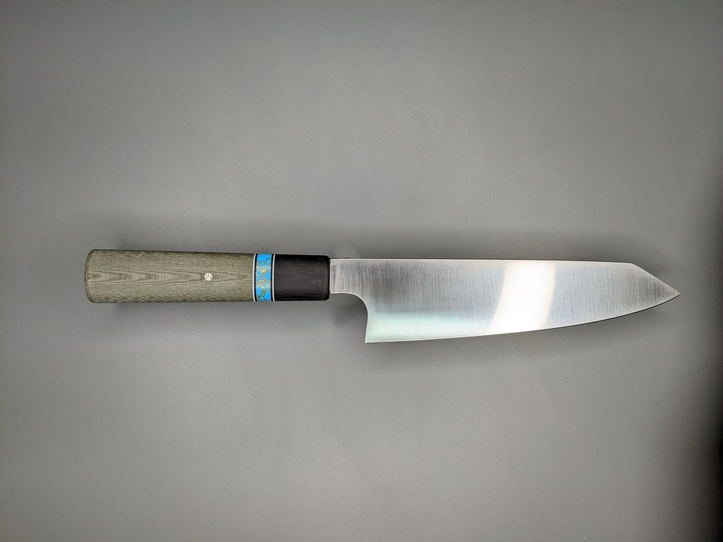 Japanese style kitchen knife with Green Micarta handle and black bolster.