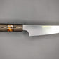 small Japanese kitchen knife with brown handle on gray background 