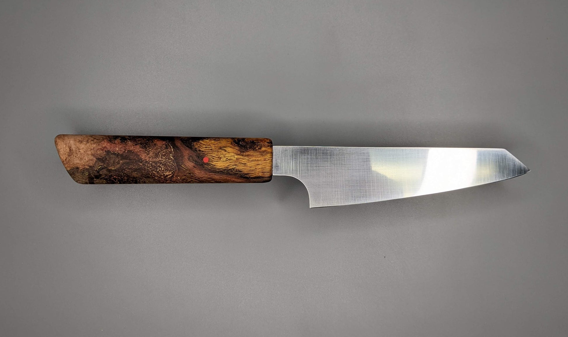 small Japanese kitchen knife with Oak wooden handle on gray background 